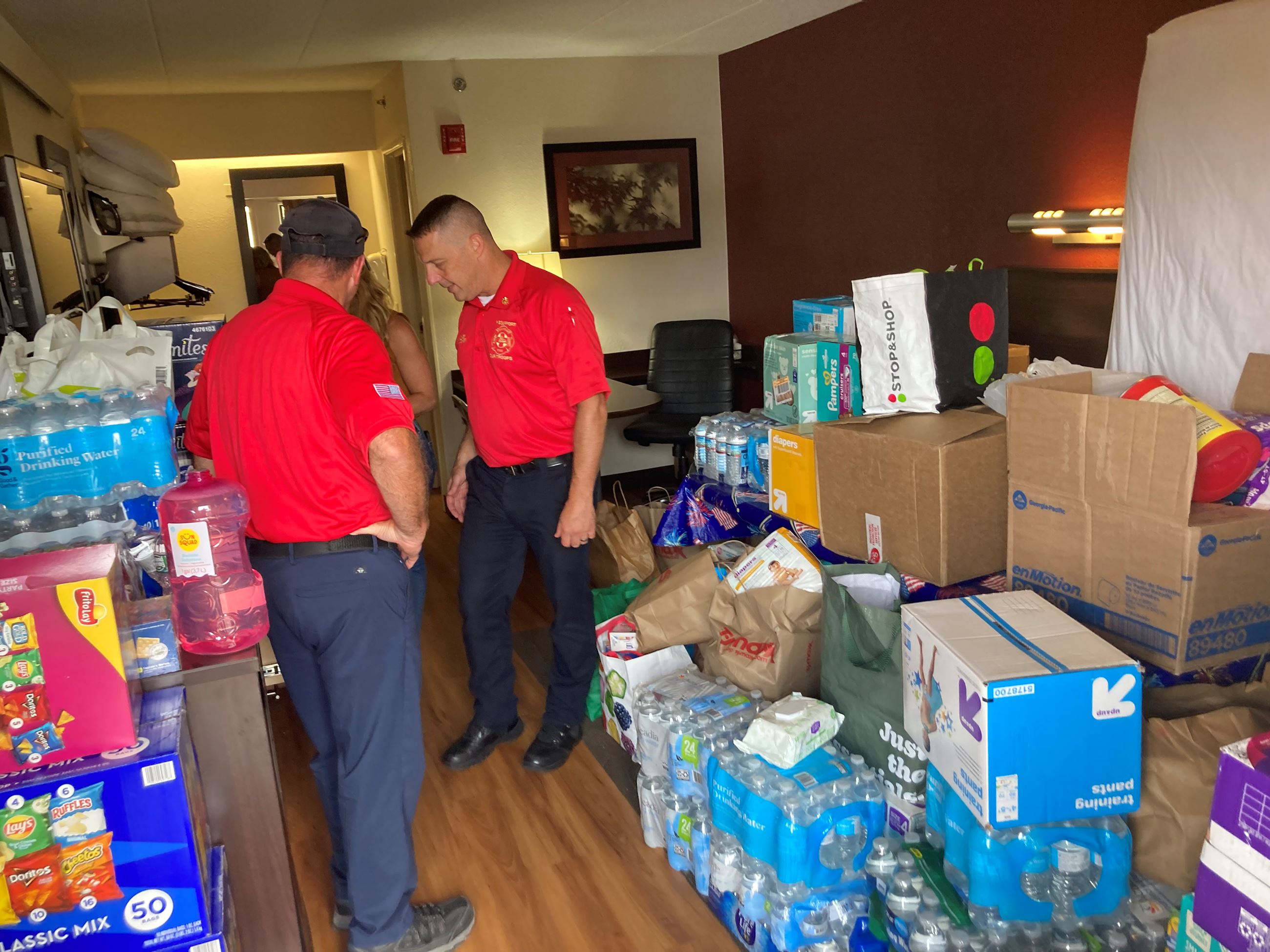 Framingham Fire Chief and firefighters drop off donations - room full of supplies